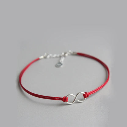 Junge Frau trägt das elegante Armband Fini mit rotem Faden am Handgelenk" "Armband Fini aus Sterlingsilber - getragen von junger Dame