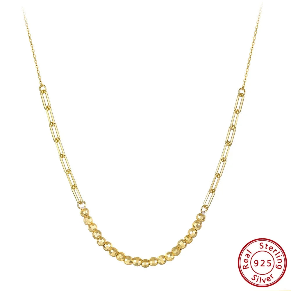 Freigestellte, goldfarbene Halskette aus 14K vergoldetem 925er Sterling Silber mit feinen, länglichen Gliedern. Das 'Real 925 Sterling Silver' Echtheitssiegel ist unten rechts sichtbar.