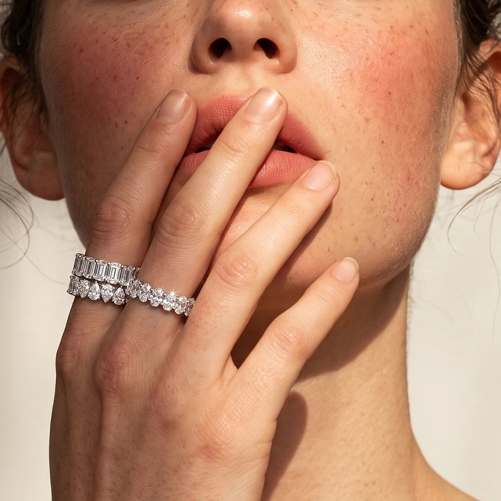 Stilvolles Portrait-Tragebild: Doppelter Zirkonia-Ring-Look mit edlem Tropfenschliff-Bandring am Zeigefinger