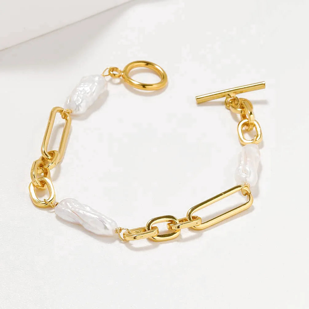 Hochwertiges Damen-Armband im Chunky-Chain-Look, kombiniert mit organischen Barockperlen und einem dekorativen T-Bar-Verschluss in Gold.