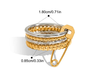  Eine grafische Darstellung eines mehrlagigen Rings mit glatten goldenen und silbernen Bändern und einem goldenen Sicherheitsnadel-Verschluss. Die Maße sind ebenfalls angegeben mit 1,8 cm Innendurchmesser und 0,85 cm Breite