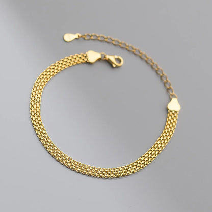 Detailansicht des stabilen Karabinerverschlusses und der Verlängerungskette mit Herz-Endkappe am goldenen Mesh-Armband