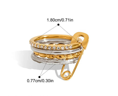  Eine grafische Darstellung eines mehrlagigen Rings mit glatten goldenen und silbernen Bändern und einem goldenen Sicherheitsnadel-Verschluss. Die Maße sind ebenfalls angegeben mit 1,8 cm Innendurchmesser und 0,77 cm Breite