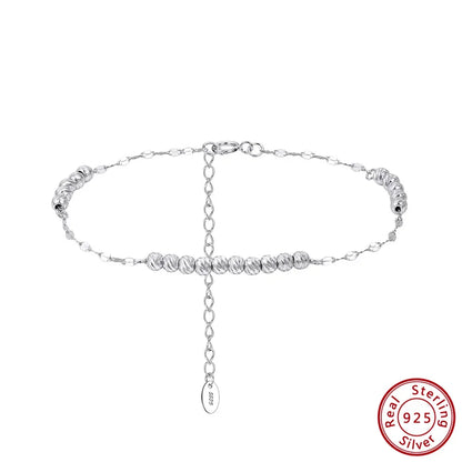 Freigestelltes, silbernes Armband aus 925er Sterling Silber mit kleinen, glänzenden Kügelchen und einer verstellbaren Verlängerungskette. Das 'Real 925 Sterling Silver' Echtheitssiegel ist unten rechts sichtbar.