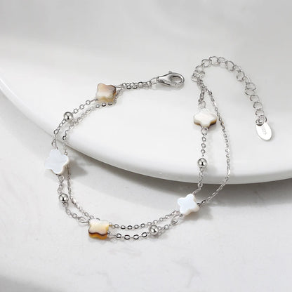 Doppeltes Gliederarmband aus 925er Sterling Silber mit weißen/beigen und schwarzen Kleeblättern.